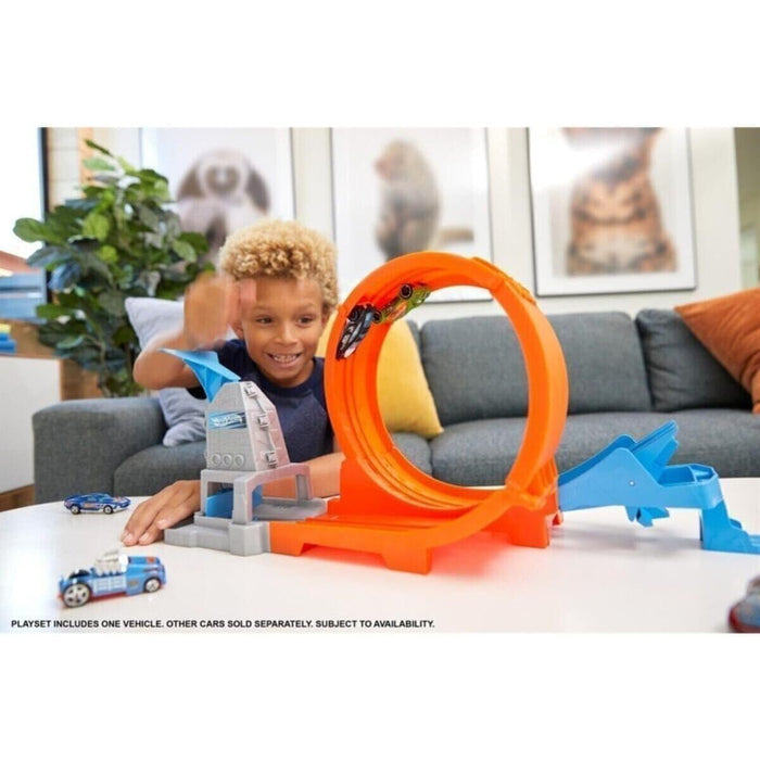 Young boy playing with Hot Wheels Action Loop in a bright living room