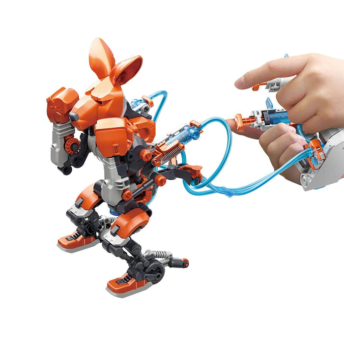 Two hands holding the controls for the orange and white Hydraulic Boxing Bot, on a white background.