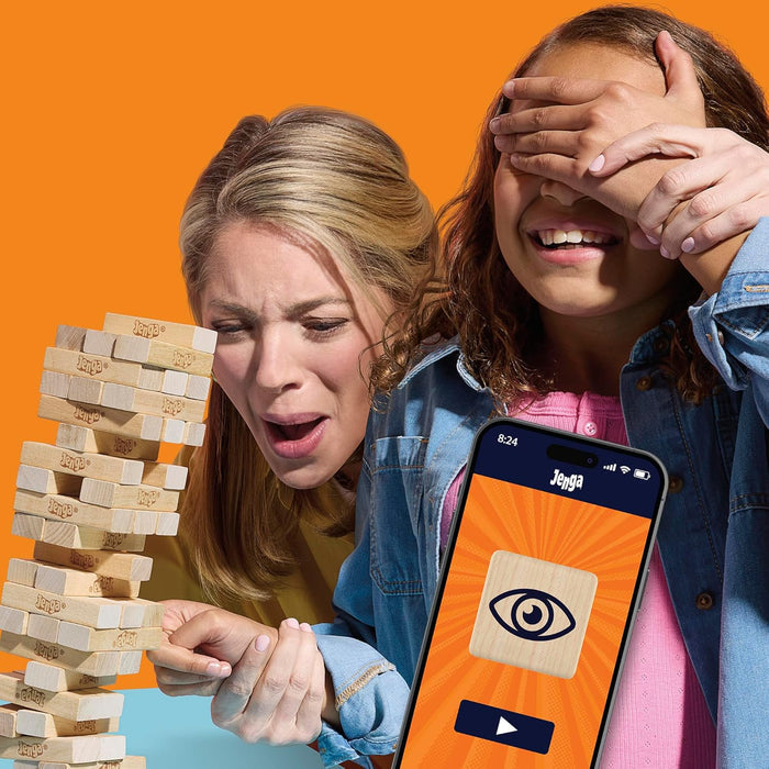 Two people playing Jenga with a smartphone showing the Jenga app interface on an orange background.