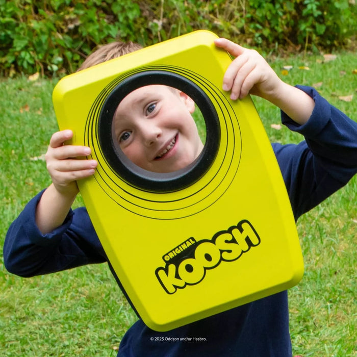 Picture of kid holding Koosh Kornhole.