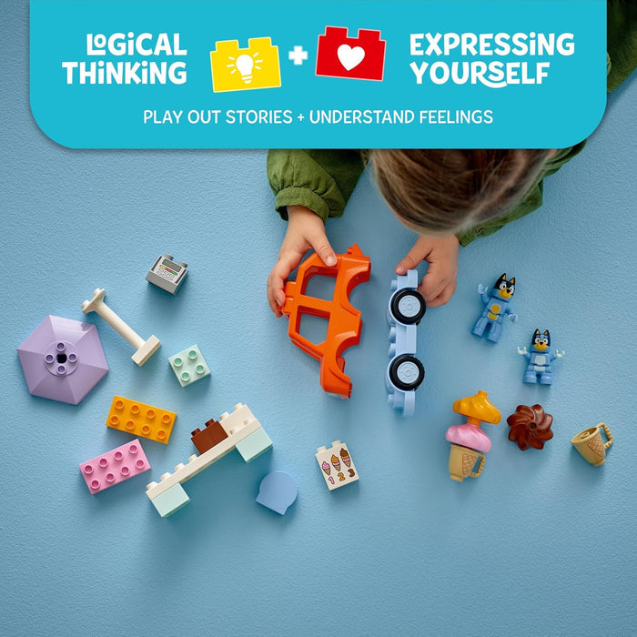 Child playing with colorful building blocks on a blue background, promoting logical thinking and expressing yourself.