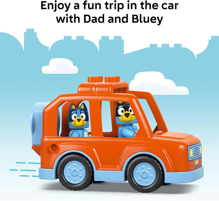 Toy car with two cartoon characters inside, set against a blue sky background.