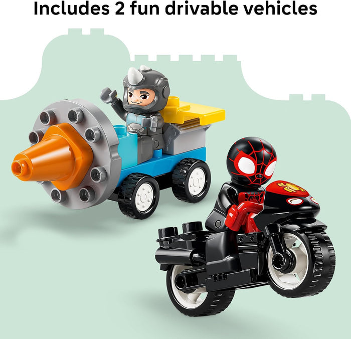 Two toy vehicles for building-block style children's play: a blue cart with an orange cone-shaped front and a gray driver figure, and a black motorcycle with red and yellow details and a spider-themed driver figure. Text at the top reads 'Includes 2 fun drivable vehicles.