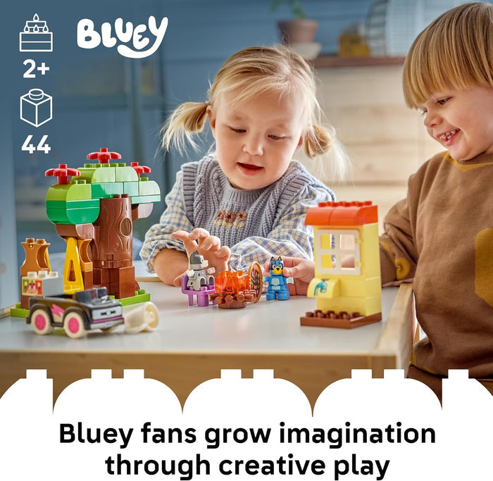 Two children playing with toy building blocks on a table, with 'Bluey' branding visible.