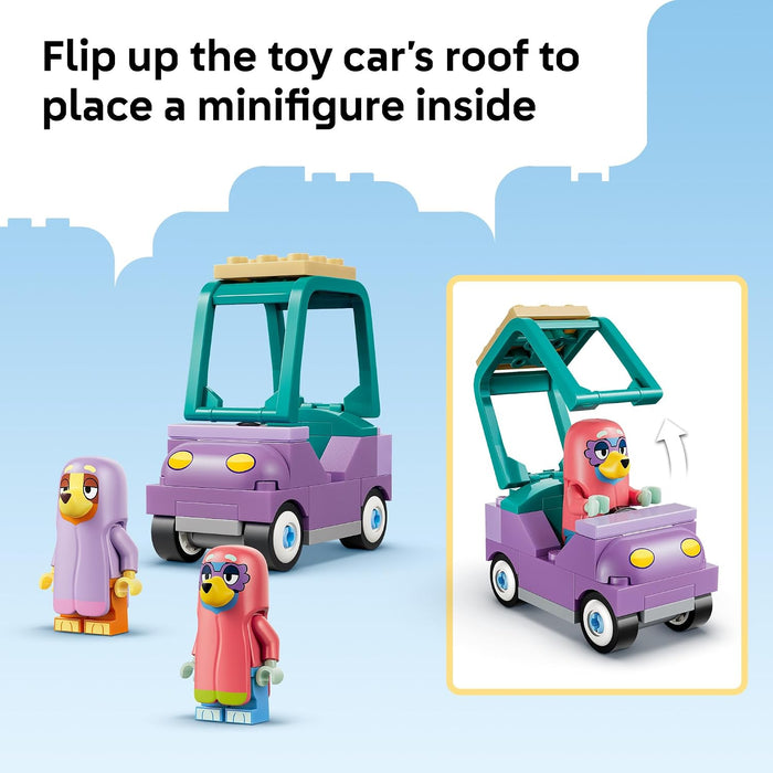 Toy car with open roof and minifigures on a blue background