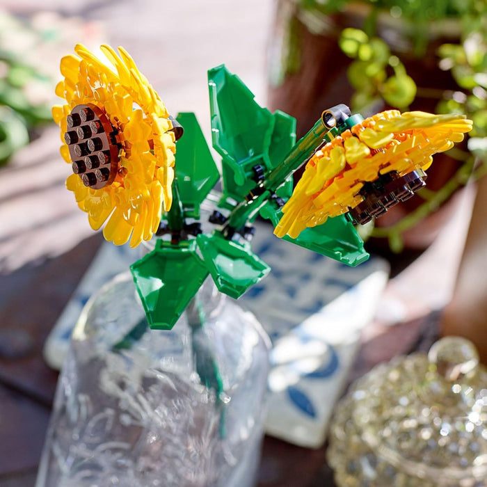 Close-up of a LEGO sunflower in a glass jar with a blurred background