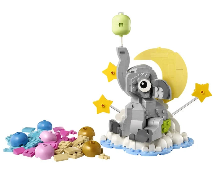 Toy elephant with stars and balloons on a white background