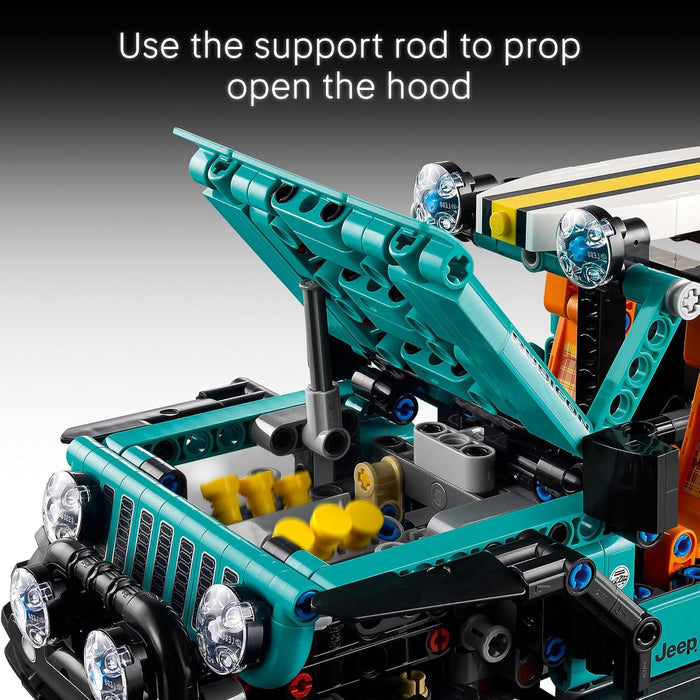 Jeep with open hood using a support rod, on a gray background.