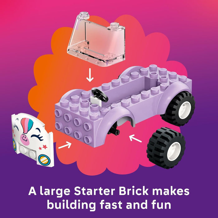 Toy building set with purple baseplate, black wheels, and pink component on a colorful background.