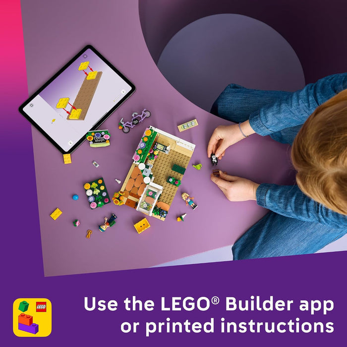 Person building a LEGO model on a purple surface with an iPad displaying a design.