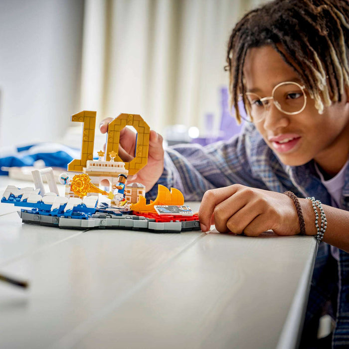 Person playing with a LEGO set on a table