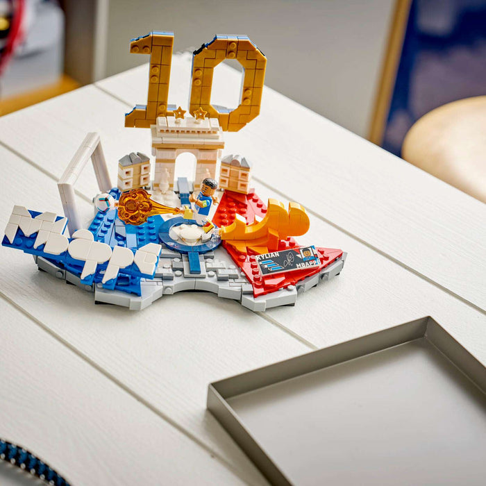 Colorful toy model of a cityscape with '10' on a white surface