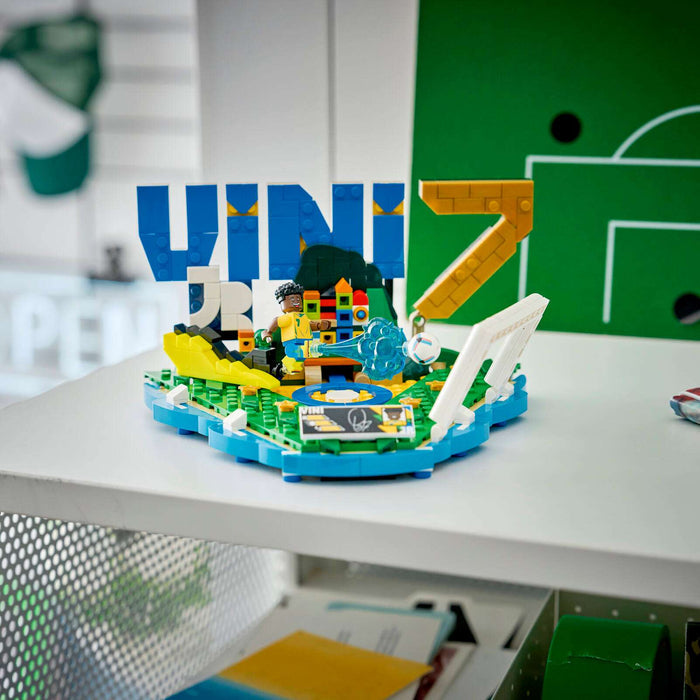 LEGO model with 'UNI' letters on a desk in a classroom setting