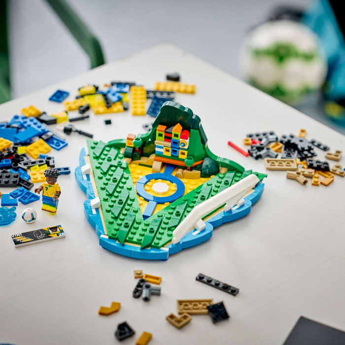 LEGO model of a dinosaur on a table with scattered LEGO pieces.