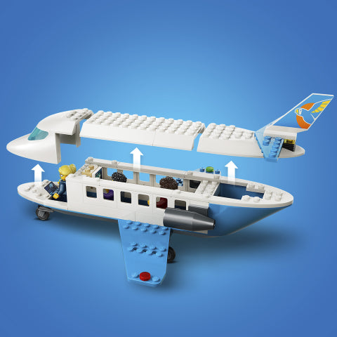 A toy cargo airplane set shown open on a blue gradient background, with white fuselage, blue wings and tail, and small multicolored passenger and cargo figures inside. White arrows point upward through the cargo hold.