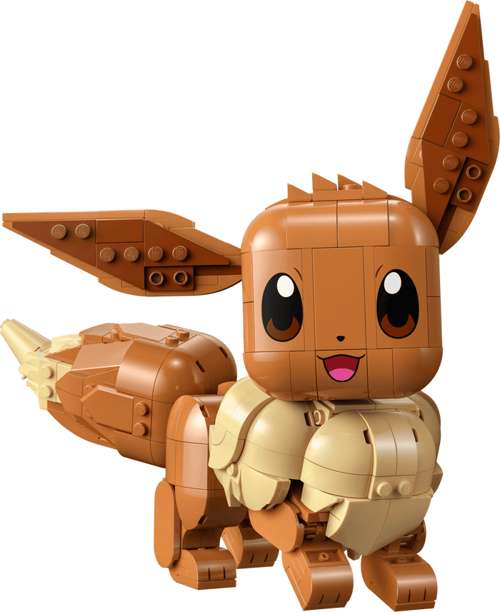 Toy figure of a brown and beige creature with large eyes and a happy expression on a transparent background