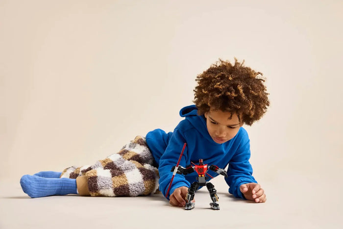 Child playing with a toy on a beige background
