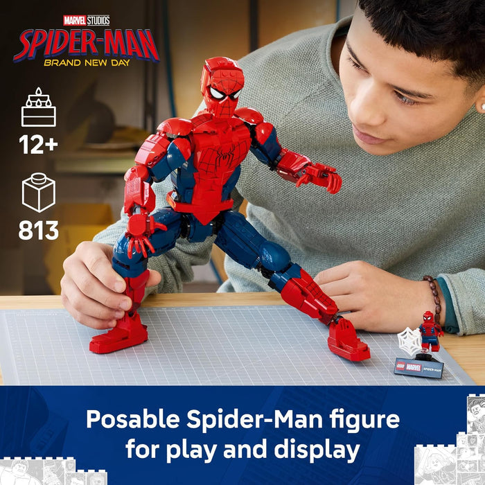 Person playing with a Spider-Man figure on a table, with Marvel Studios branding.