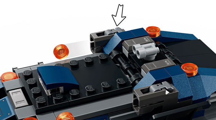 Close-up of a LEGO model with a focus on a specific piece, indicated by an arrow.