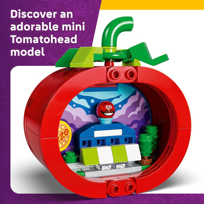 Toy model of a Tomatohead character inside a red apple with colorful interior, on a purple and white background.