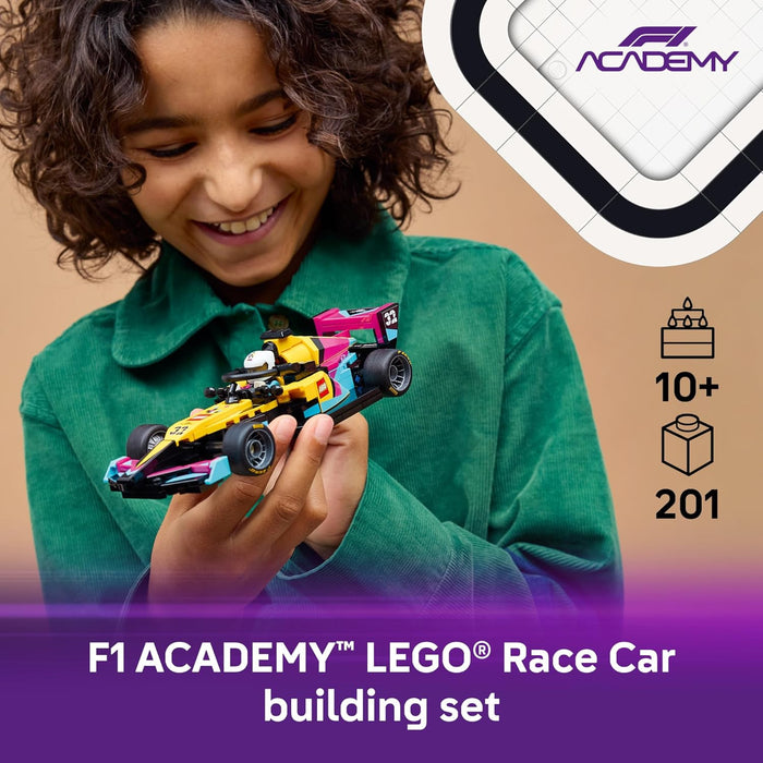 Child holding a LEGO F1 Academy race car set with branding elements.