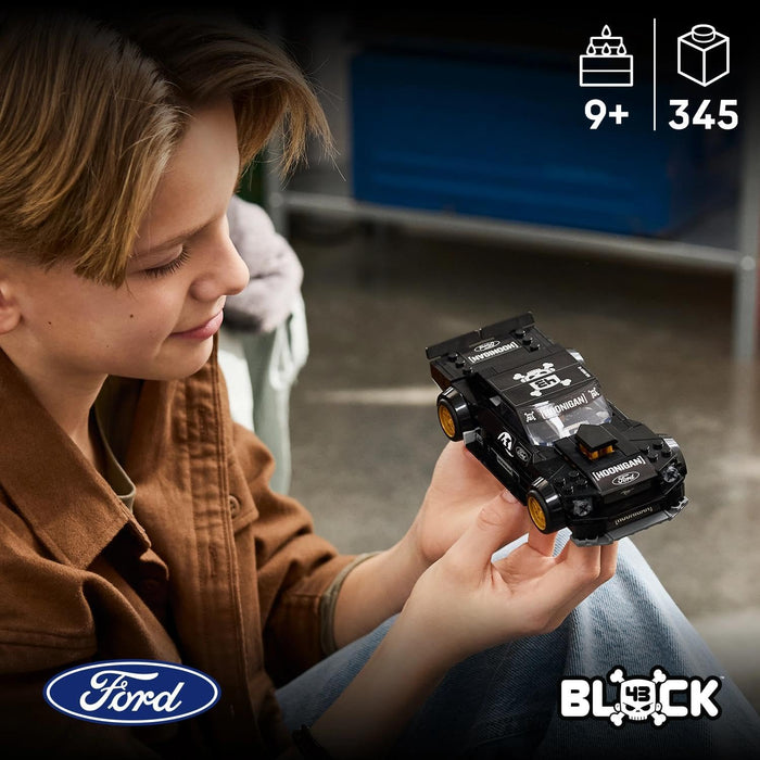 A child in a brown shirt holds a black Ford Block toy car with gold wheels. The image includes age and piece count icons in the top right and the Ford and Block logos at the bottom.