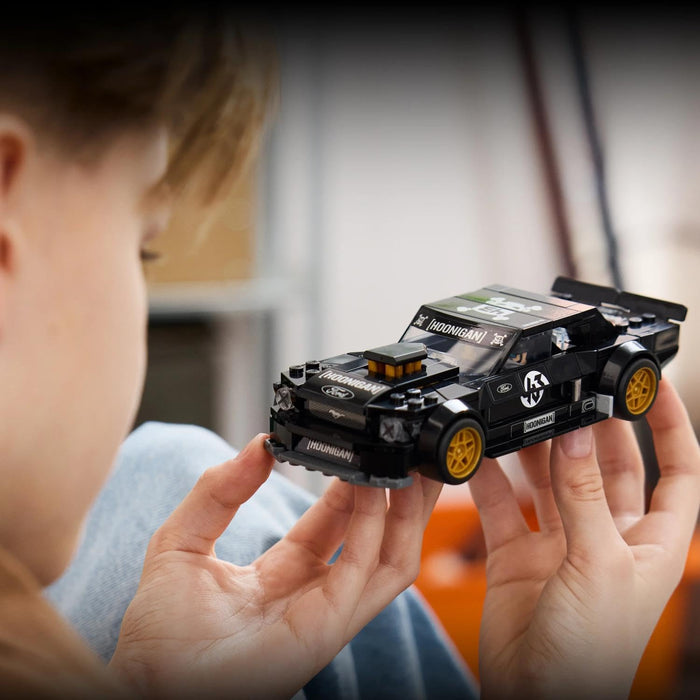 Child holding a detailed toy car model