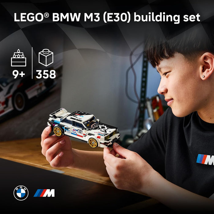 A child holds a small LEGO BMW M3 racing car set while wearing a black LEGO BMW M shirt. The image includes text overlays stating 'LEGO BMW M3 (E30) building set' and product icons indicating 9+ age, 358 pieces, and a cake topper.