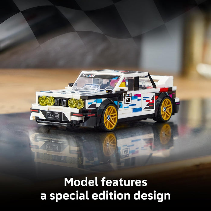 A toy model of a white BMW M3 race car with blue, red, and black racing decals, yellow wheels, and a checkered flag background. Text at the bottom reads 'Model features a special edition design'.