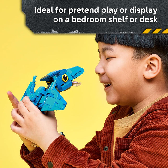 A child in a rust-brown corduroy jacket holds a bright blue dinosaur toy against a solid yellow background, with promotional text at the top about using it for pretend play or display on a shelf or desk.