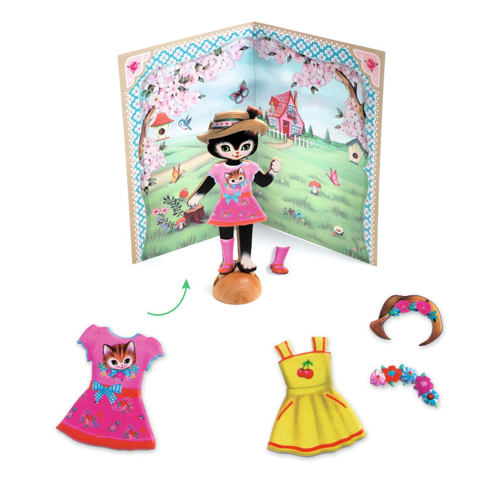 Contents of Little Wardrobe Collage featuring on dress up cat, one pink and one yellow outfit, accessories on a white background
