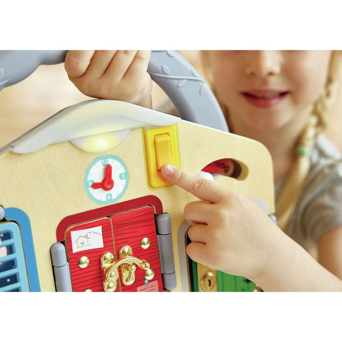 Close up a section of the Lock and Learn Playboard with a child pressing a yellow switch