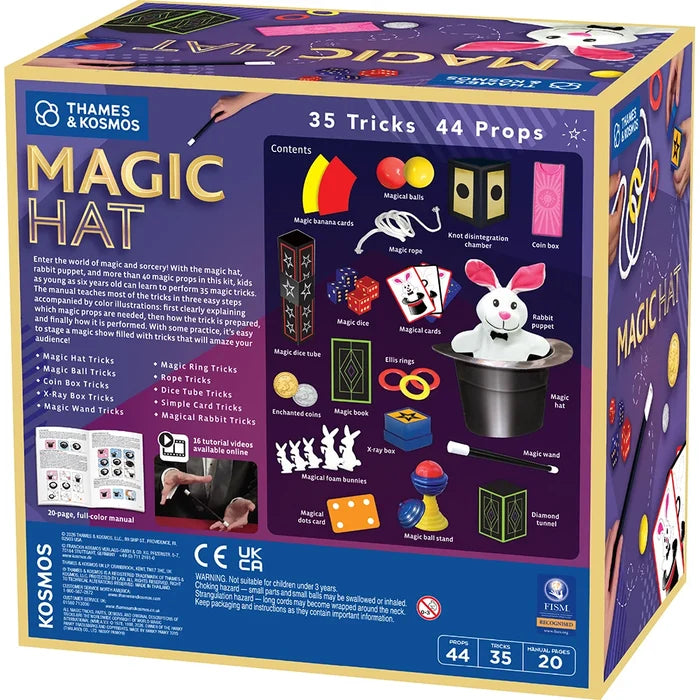 The retail packaging box for the Thames & Kosmos Magic Hat toy set, featuring a colorful front panel with illustrations of the included props and tricks, and a blue base with age and quantity information.