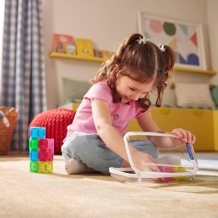Child placing Magna Tile Cubes into their storage case in a playroom