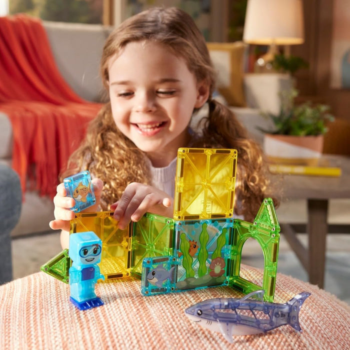 Child playing with Shark Dive Magna Tiles in a bright living room