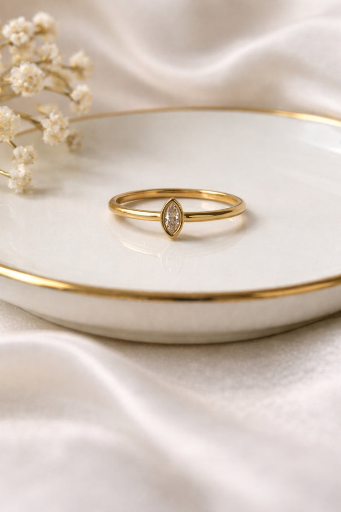 Minimalist marquise gold ring 18k PVD stainless steel ring on ceramic dish soft neutral styling