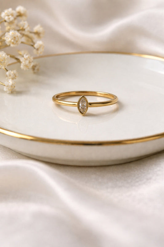 Minimalist marquise gold ring 18k PVD stainless steel ring on ceramic dish soft neutral styling