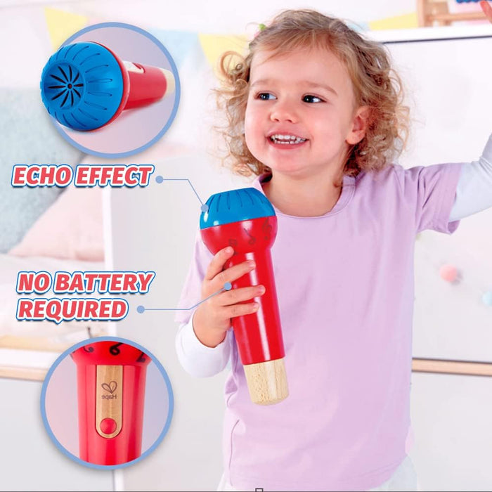 Child holding a red and blue toy microphone with echo effect feature, no battery required.