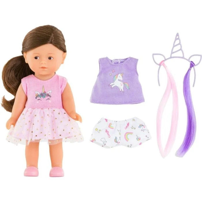 Doll with pink outfit and accessories on a white background