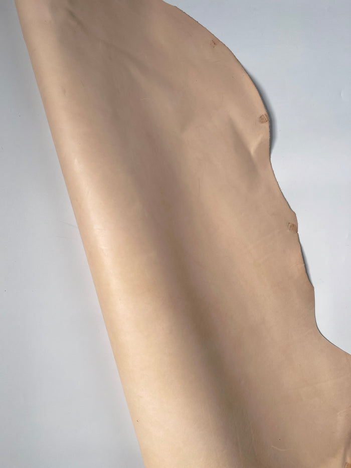 Close view of Natural Veg Tan Tooling Cowhide grain and firm temper