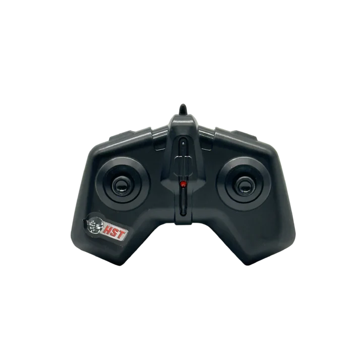 A black plastic dual-stick remote control transmitter with a small red switch in the center and a white and red HST logo on the lower left, shown against a plain white background.