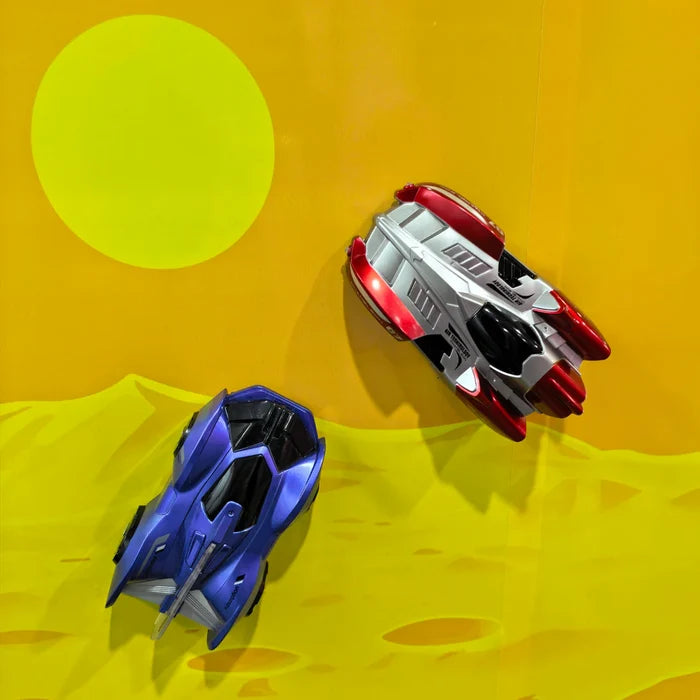 Two toy car RC's, one blue and one red and white, on a yellow surface with a large green circle in the background.