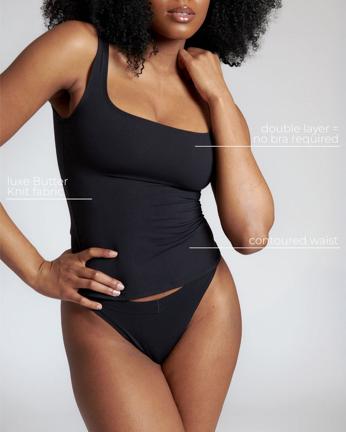 Woman wearing a black tank top and underwear on a gray background with text describing the top