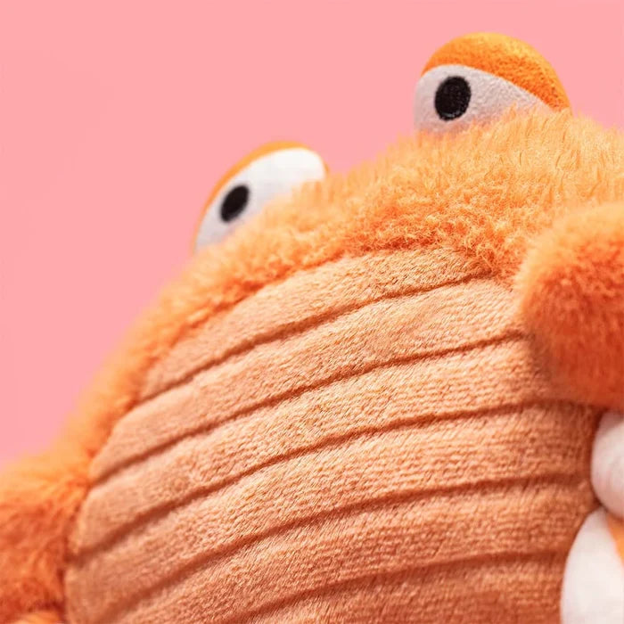Close-up of a plush toy with a pink background
