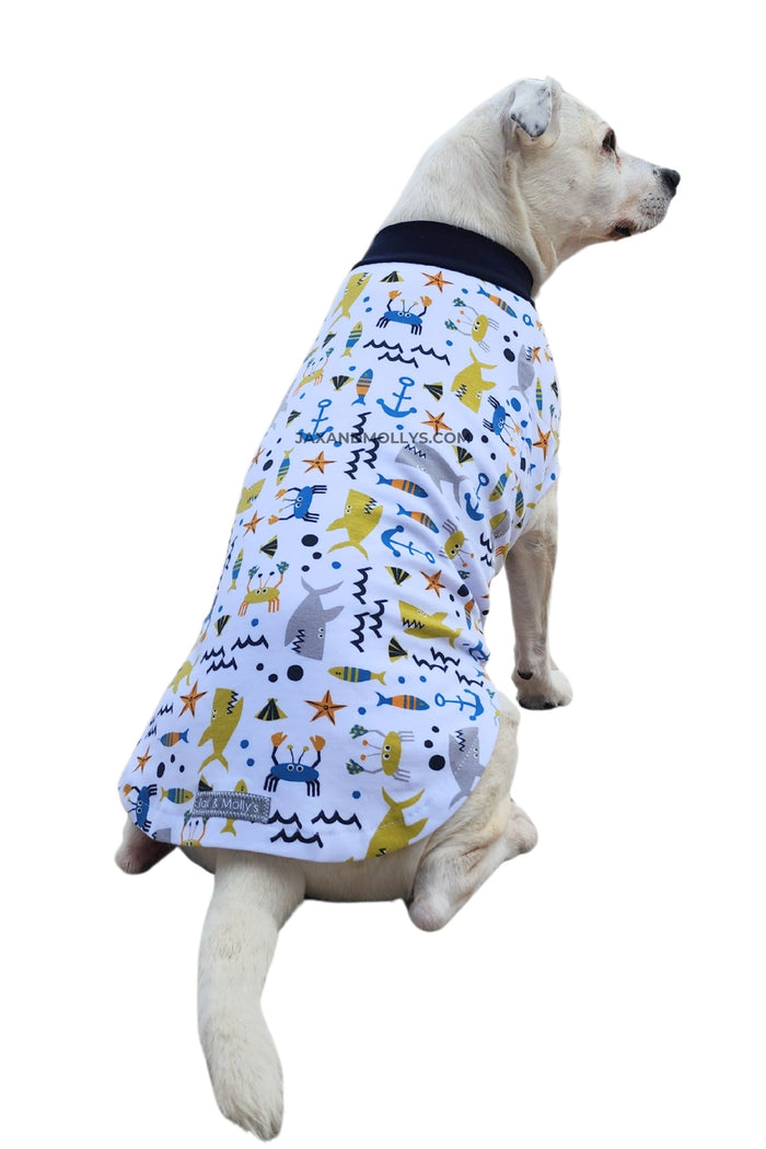 Playful Fish & Sharks cotton-spandex dog pajamas on white dog, back view sitting