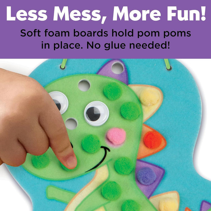 Child's hand interacting with a colorful foam craft project on a white background