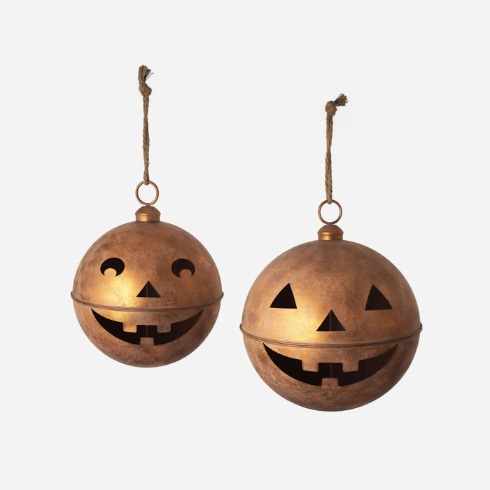 Pumpkin Bell Display - large hanging jack-o'-lantern lanterns with a copper finish and playful cutout faces.