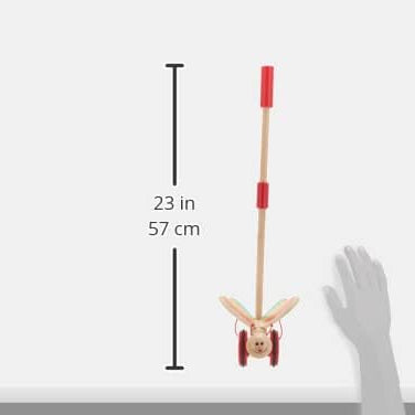 Measurement of the butterfly push toy, 23 inches, with a hand for scale on a white background