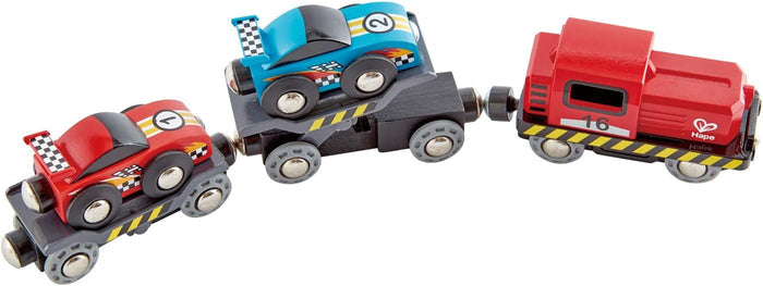Red train engine pulling a blue and red race car on a white background