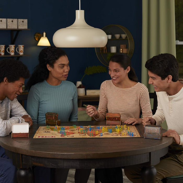Four friends playing Risk together in a cozy living room.